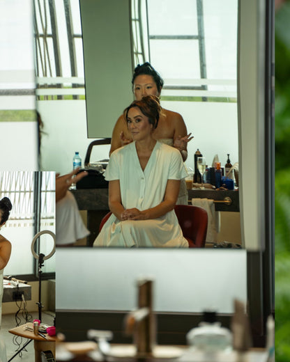 Woman getting hair and makeup done in glam gown